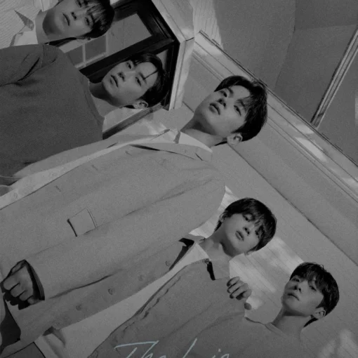 Black-and-white promotional photo of five young men posing together, for a Korean music release, with Korean title text along the bottom and small English watermark top-left