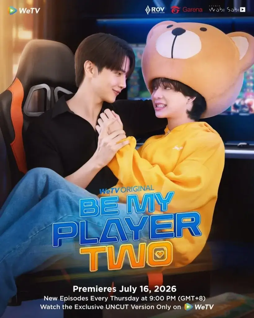 Promotional poster for WeTV's Be My Player Two featuring two young men holding hands, one wearing a bear hat, with premiere date July 16, 2026.